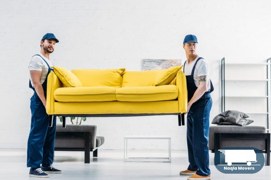 Naqla Movers crew carrying a sofa during an apartment move in Dubai