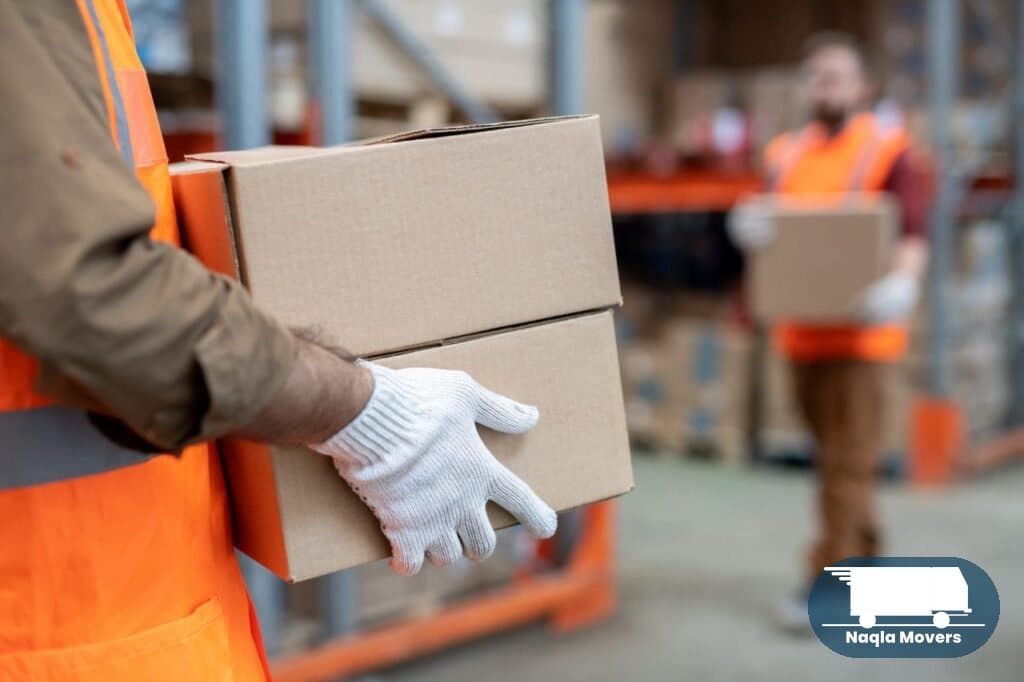 Naqla Movers team organizing storage inside the warehouse