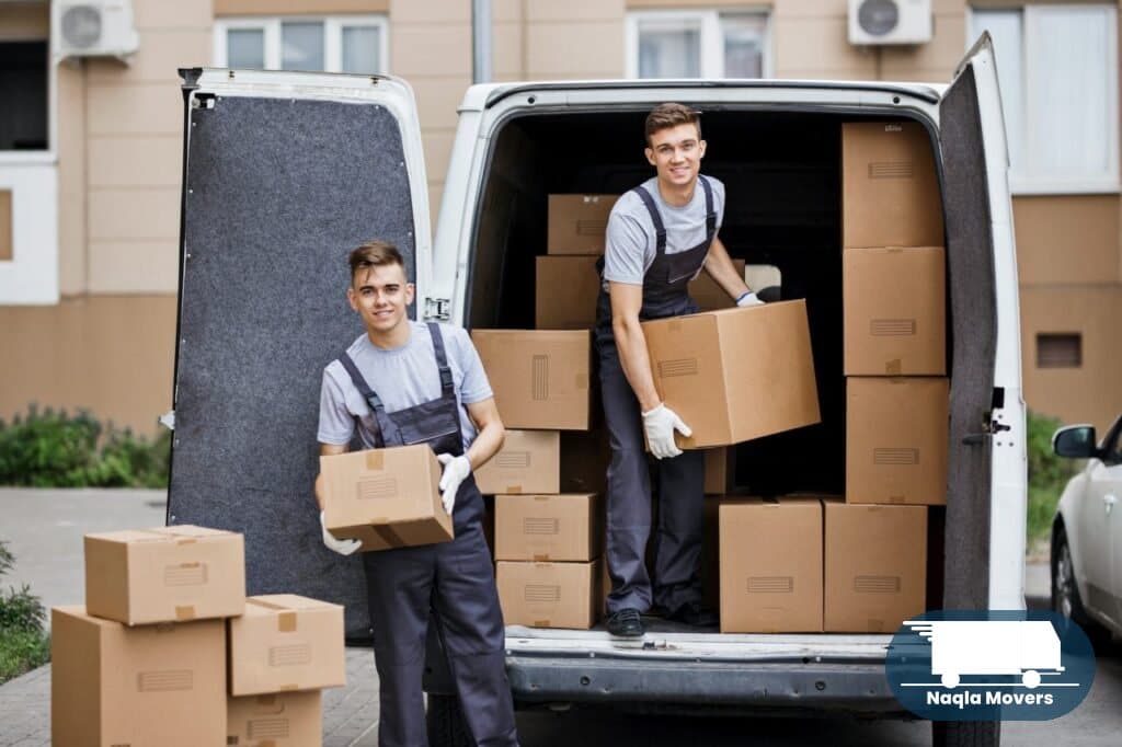 Naqla Movers crew loading a moving truck with packed boxes in Dubai